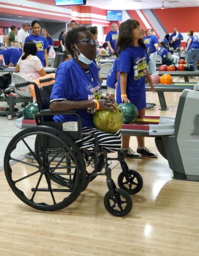 Amputee in wheelchair bowling