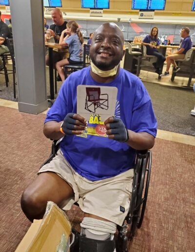Man in wheelchair holding gift