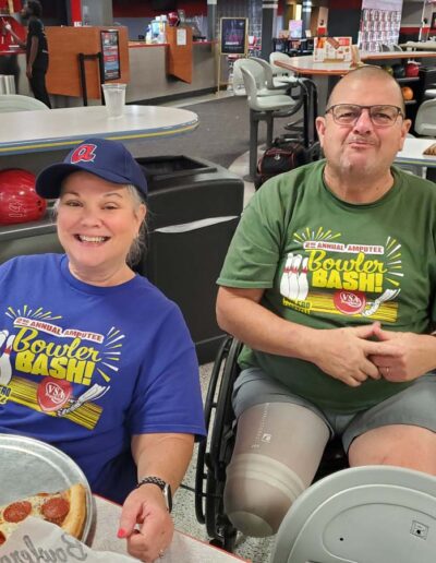 Man in wheelchair and woman at bowling alley