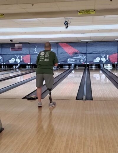 Man with prosthetic bowling