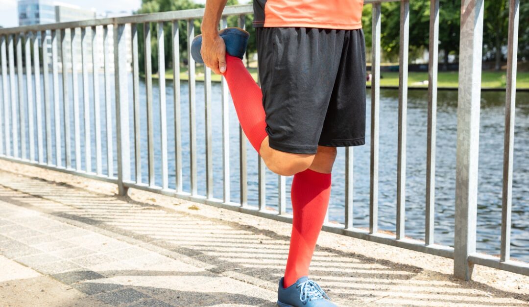 Male runner stretching his legs