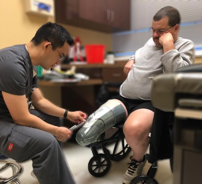 Prosthetic patient in the VSA Prosthetics office, being treated by Dr. Chen.