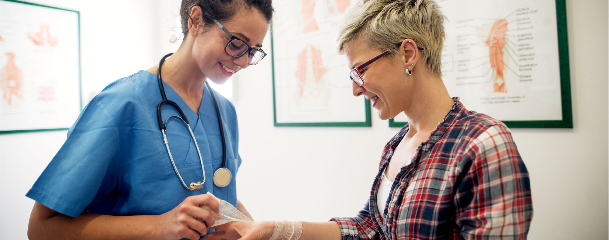 Physician helping patient with a wound on her arm.