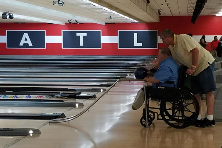 Man in wheelchair bowling