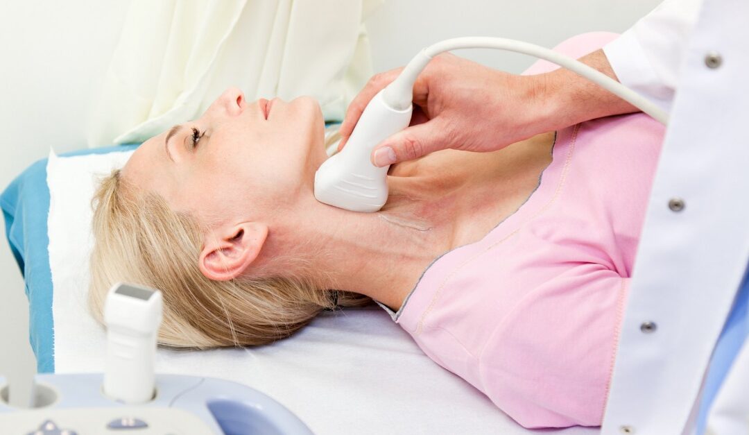 Woman receiving ultrasound test on neck