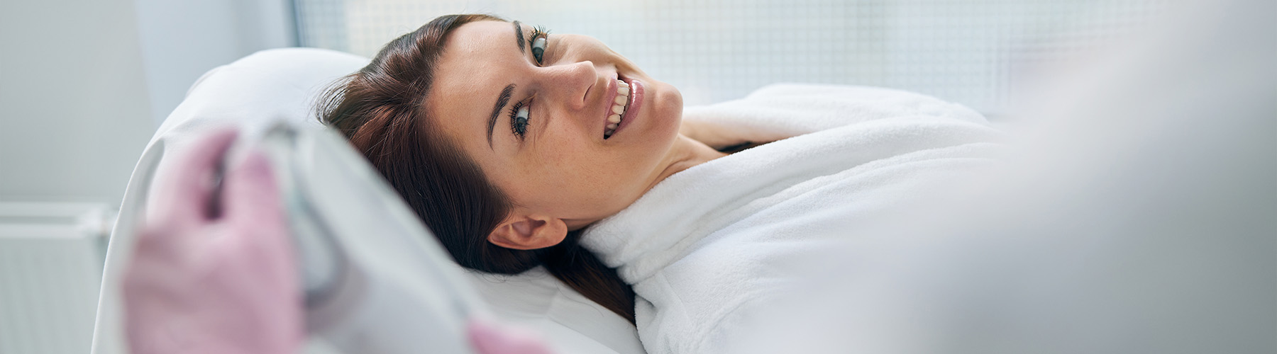 Smiling female ready for an ultrasound